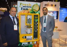 Remy Cima and Michel Keeken with Dutch Food Technology proudly show the Pinabar. In a matter of seconds, this machine peels and cuts pinapples and drops the chunks in a ready-to-go container.